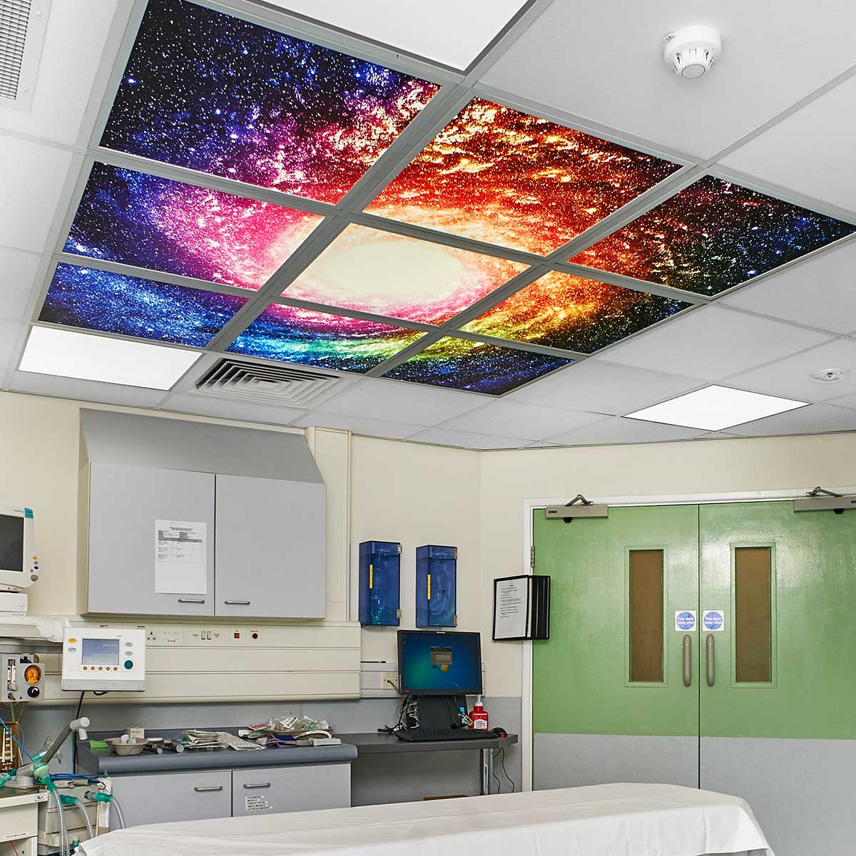 A vivid & colourful display of a spiral galaxy with a collection of stars placed within a hospital room space.